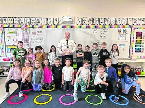 Sussex County Sheriff Michael Strada poses with first-graders at Ogdensburg Elementary School.