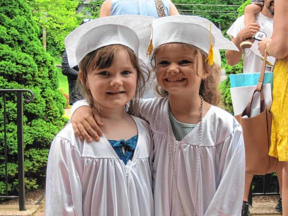 Preschool’s last graduation Amelia Arnone, 4, and Ava Pereira, 5.