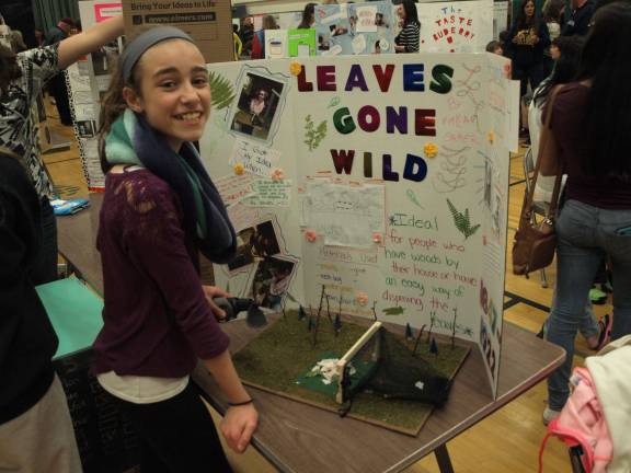 Kayla Baker, 11, demonstrating her leaf catcher &#x2014; a net for capturing blown leaves.