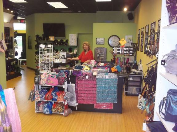 Handbags and shoes and friends galore Owner Annette Dizenzo inside the store.