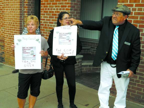 Local citizens protest government shutdown Bill Weightman (right), Democratic candidate for Assembly from the 24th District, joining with picketers in front of Congressman Scott Garrett's office, Friday October 4, 2013