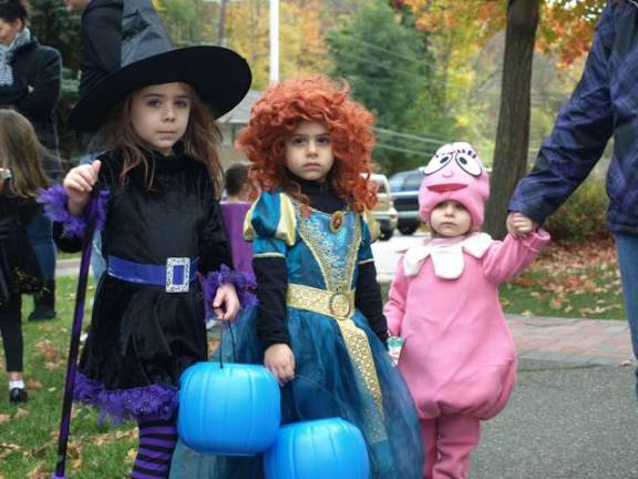 From left, Holly, 6; Autumn, 5; and Taylor ,2, Carpentier of Ogdensburg before the start of the Halloween Parade through Ogdensburg Sunday afternoon.