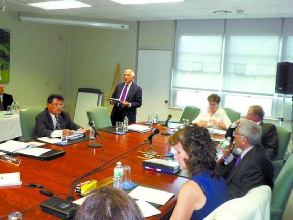 photo by nathan mayberg Attorney William Maderer presents the Sussex County Community College Board of Trustees with Saiber law firm's report on the bid process for the $2.88 million student center construction project.