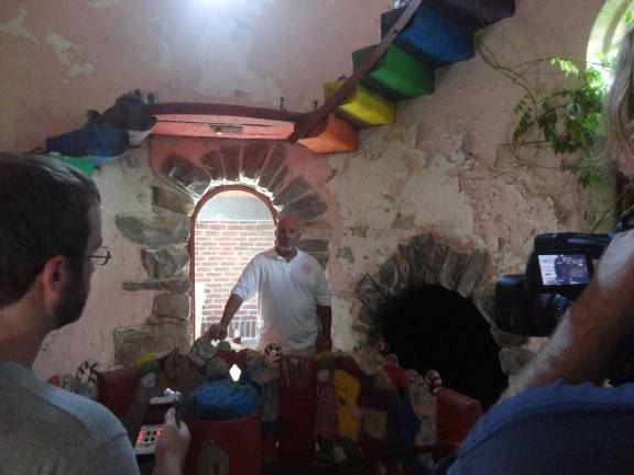 Hamburg Councilman Dan Barr stands inside the tower at Gingerbread Castle while being interviewed on film for an upcoming documentary.