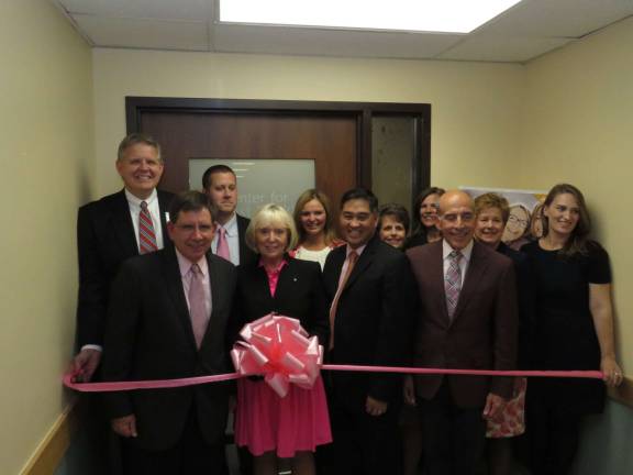 Members of the hospital, the hospital Foundation and supporters gather for the ribbon-cutting at the entrance to the breast center.