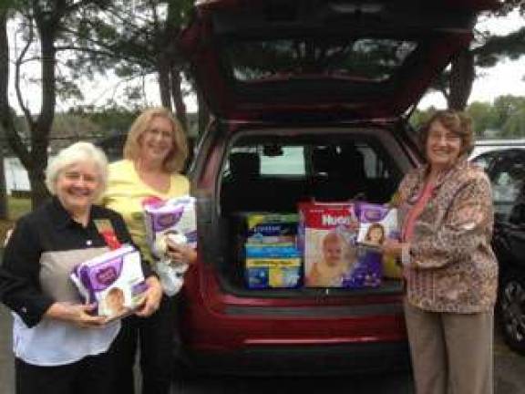Pictured from left to right loading a car full of supplies to be delivered are Connie Fadden, Barbara Henderson and Evelyn Plumbafter their fall meeting at the Trout and Troll in Stanhope.