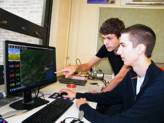 Photos by Viktoria-Leigh Wagner High Point High School seniors Bob Burghart, left, and Corey Orlovsky make adjustments to their quadcopter.