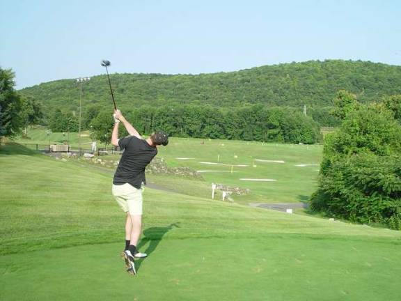 J.T. Wilson demonstrates good form in hitting his tee shot 274 yards in the long drive competition.