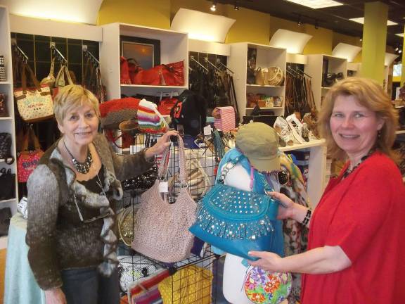 Photos by Don Carswell Annette Dizenzo assists shopper Ilsa Bordman with a purchase.