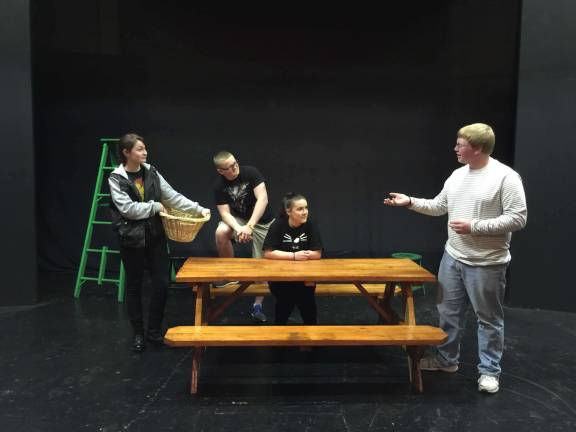 Stage Manager, Matthew Fralley (standing) assists (from left to right) Emma Birmingham, Jerome Beyer and Kerry Opperman in rehearsal.