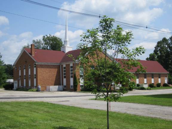 A sugar maple tree is planted with Crossroads Assembly of God church in background.