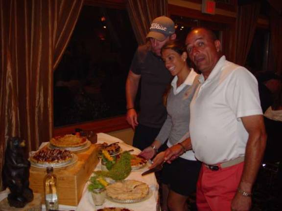 Golfers in the Bourbon, Barbeque and Blue Grass Golf Outing enjoy the treats in Desert Station of the barbeque.