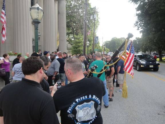 Members of the Morris County Pipe and Drum Band look over some of the news on Councilman Dave Fanale.