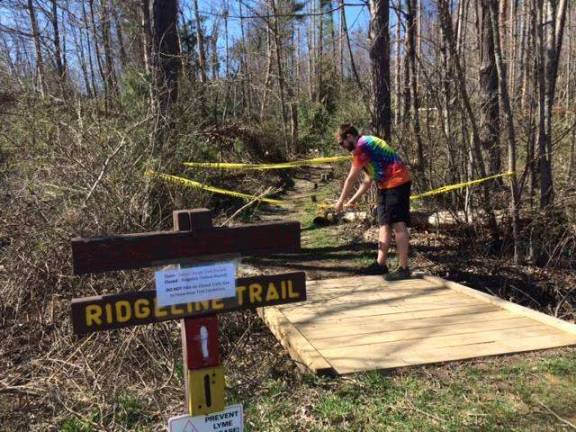 Trails are reopening at the park A worker clears a trail at the Pocono Environmental Education Center (PEEC) (PEEC Facebook photo)