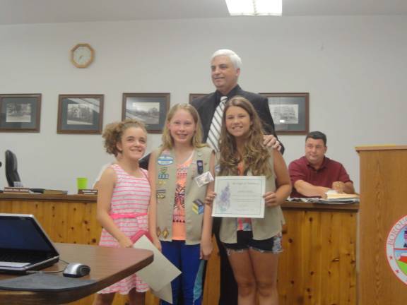Hamburg Mayor Paul Marino recognizes members of Hamburg Cadet Girl Scout Troop #793 for volunteering their time to beautify Hamburgs Recreation Park. Pictured are Hamburg scouts Jessica Haig, Ashley McLean and Samantha Milfort.