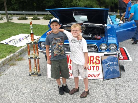 Car Warriors enjoy the fruits of their labor Photos by John Church Justin (left) and Giancarlo Valenzuela of Sparta are Car Warrior fans and friends of builder Rene Vega. "I knew he would win from the start," said Justin.