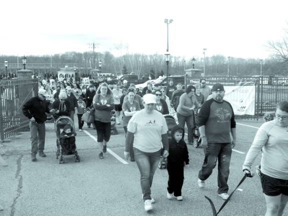 Many of the walkers hugged themselves to stay warm at 9 a.m. Sunday.