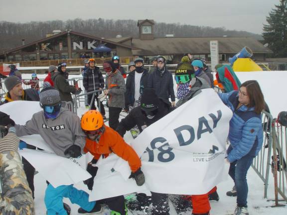 Eddie Murray, Justin Lamert, James Neebling and Joe Bellotti break through the Opening Day Banner to kick off the season.