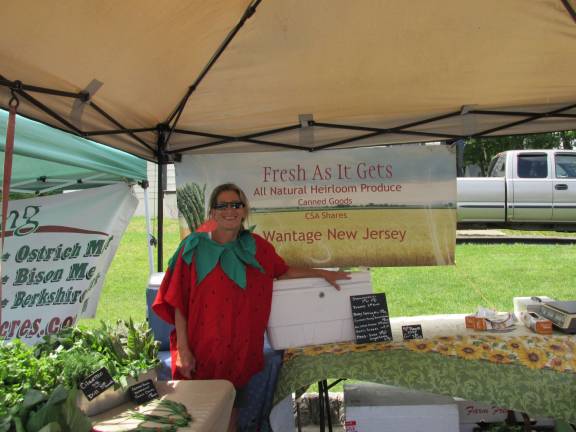 Local folks, farms and food meld together at Farmers market Shawna Bengivenni, of As Fresh as it Gets, poses with her veggies. She's wearing a Strawberry suit as Saturday was the markets Strawberry Festival. Bengivenni's farm is in Wantage where she lives with her husband, Lou, and their goats.