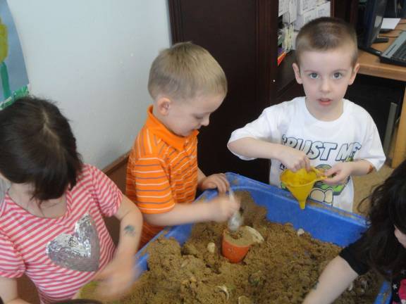 Great Beginnings celebrates Day of the Young Child William Gunderman, 4, of Hamburg, and Layne Swanson, 4, of Franklin, make sand castles.