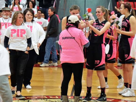 High Point basketball raises money for cancer survivors Cancer survivors receive roses, hugs, and I am a cancer survivor medallions.