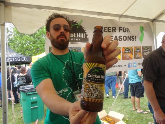 Rob Cottignies, of Fairfield's Cricket Hill Brewery, shows off a bottle of their flagship Jersey Summer Breakfast Ale.