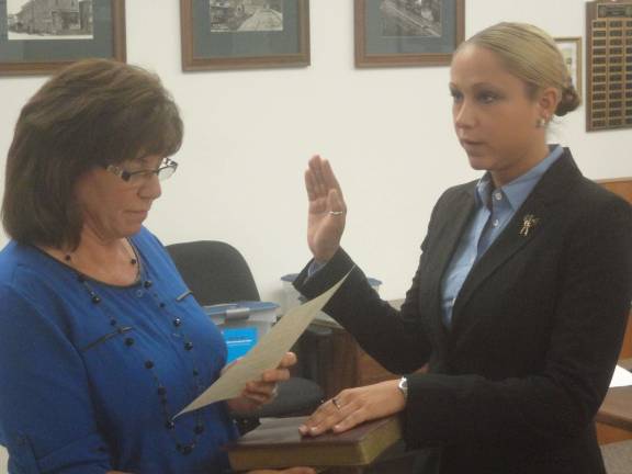 Hamburg hires new police officers Photos by Scott Baker Dana Black is sworn in by borough clerk Doreen Schott.