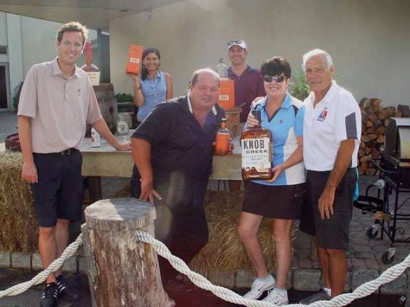 The foursome of Matt Eager (left), Buffy and John Whiting (right) and Mike Bellace (back right) stop at sponsor station to sample their product with Keith and a member of the Crystal Springs staff .