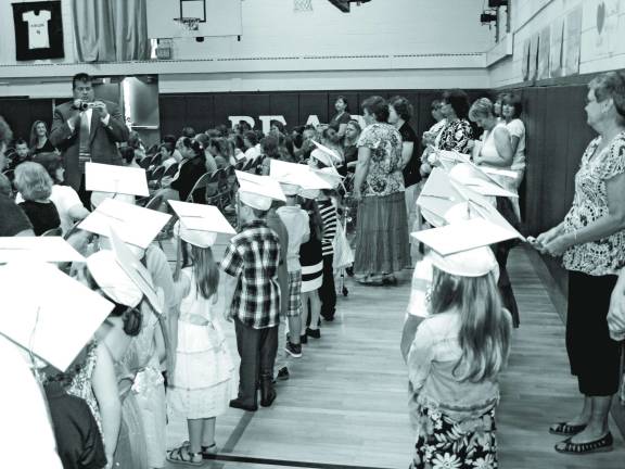 The kindergarten class of 2014 lines up in the gymnasium.