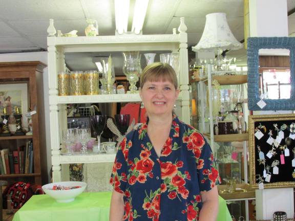 Jo Junque Antiques n' Stuff opens with celebration Photos by Laurie Gordon Joanna West, owner, poses at the front of her store