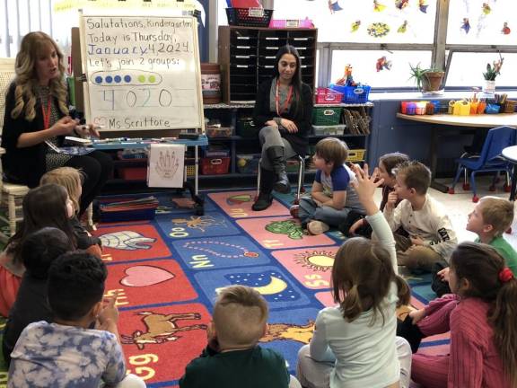 Tara Scrittore, left, does some basic math with her kindergarten students at Hamburg School. At right is paraprofessional Enza Ramos.