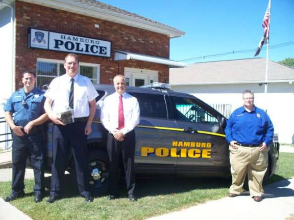 Pictured from left are Officer Jason Tangora, Hamburg, Germany, police officer Kai Biewendt, Police Director Wayne Yahm and William Schievella are shown.