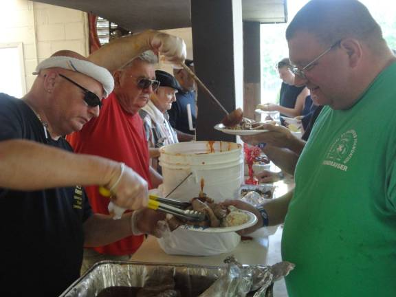 Fire victims host luncheon to honor firefighters Volunteer firefighters and their families get heaping helpings of roast beef and pulled pork, courtesy of the SS Diner and Green Valley Farms. Photo by Scott Baker