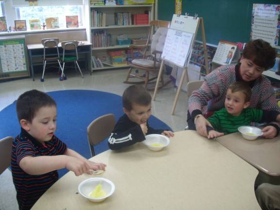 Franklin preschoolers build skills with pudding C.J. Werdann, Anthony Vacante, Drew Babcock and teacher Sharon Wylie taste the pudding.