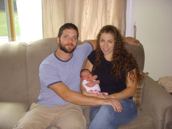 Clark and Keri Curtis hold their daughter, McKayla Rose, who was born on the side of Thornlot Road on July 25 in Vernon Township. Photo by Mike zummo