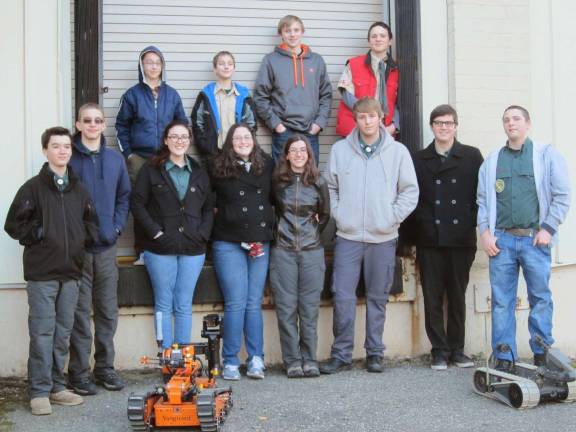 Venturing Crew visits Picatinny Arsenal Crew photo outside EOD (Explosive Ordinance Disposal) building with bomb disposal robots.