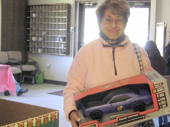 Emily Bazelewich of Franklin makes a toy donation (Photo by Janet Redyke)