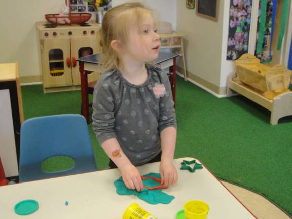 Great Beginnings celebrates Day of the Young Child Aubree Baldassano, 4, uses a mold to make Play-Doh fish.