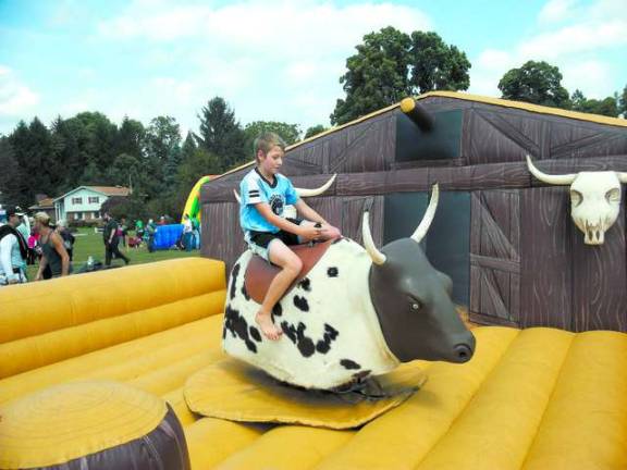 Michael Galderisi tries to tame the mechanical bull.