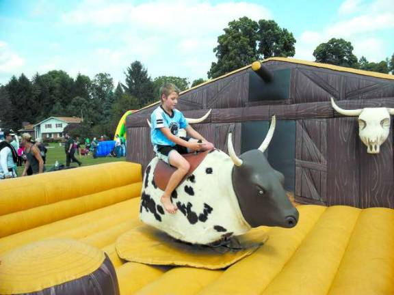 Michael Galderisi tries to tame the mechanical bull.