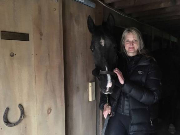 New business offers therapy through horses Diane standing with Jet.