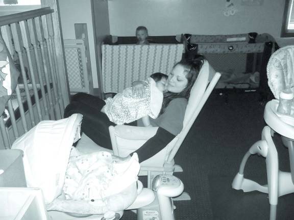 ‘Growing and Knowing’ fulfills a mother’s dreams Mrs. Flo rocking baby Brooklyn in her arms, baby Emma in the swing and baby Logan is waking up from his nap in the background.