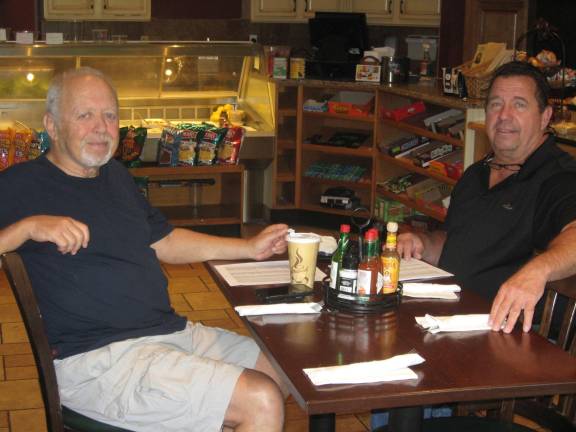 PHOTO BY JANET REDYKE Bruce Zaretsky (left) and Chris Lennon sit and chat in Smokey&#x2019;s Brick Oven Tavern about their recent test drone delivery.