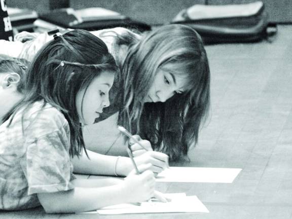 Melissa Marchionda (left) and Renee Rizzo practice drawing Tuesday morning.