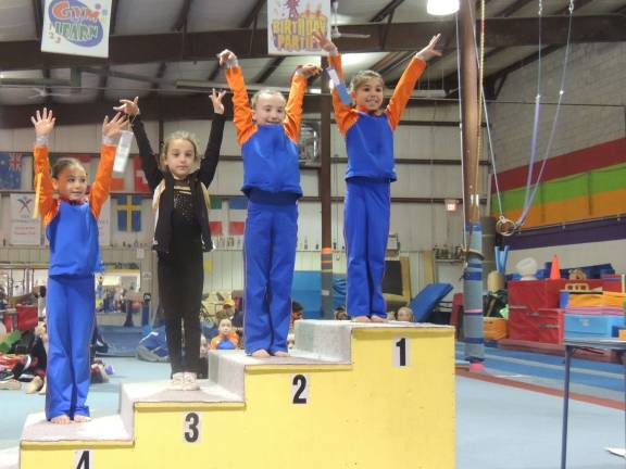 Cameron Volpe, Meghan Smith and Shea Cina place for the vault