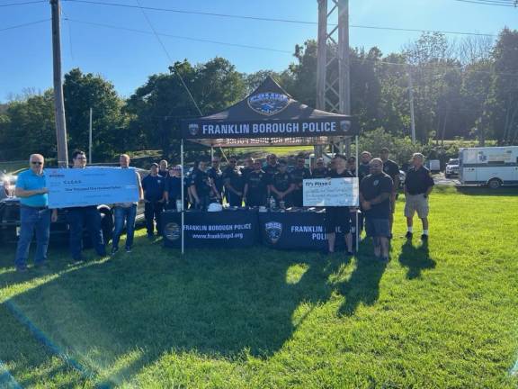 R Wireless and TJ’s Pizza presented checks to the Community-Law Enforcement Affirmative Relations (C.L.E.A.R.) program and the Center for Prevention &amp; Counseling in Newton.