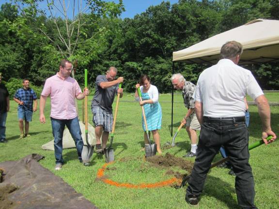 Hamburg church holds tree planting Pastor Bryce Curtis, left, is shown digging with his wife, Kaydee.