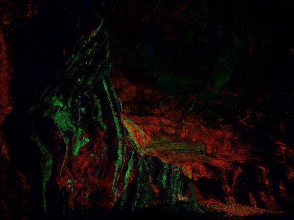 The fluorescent outcropping is illuminated by UV lights.