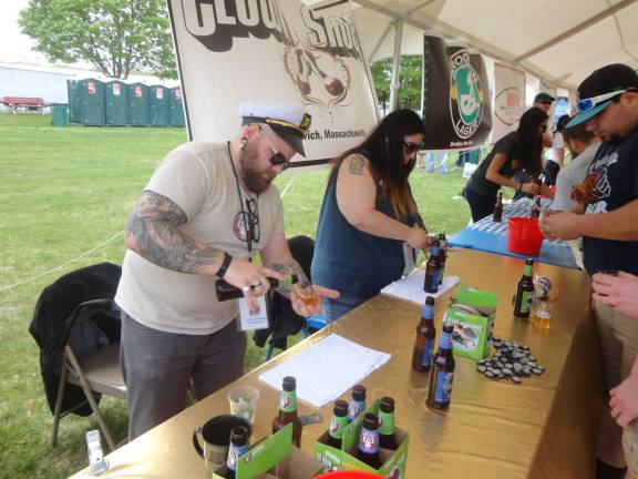 Steve von Grimm, of Newton, and Laura Cidgeman, of Fort Lee, pour samples of Clown Shoes Brewing's most popular beers.
