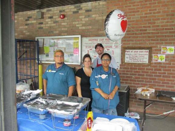 From left, Nick Alamo, Patti Holster, Joe Italiano, and Beverly Ruddock man the grill outside of the Franklin ShopRite where they make snacks.